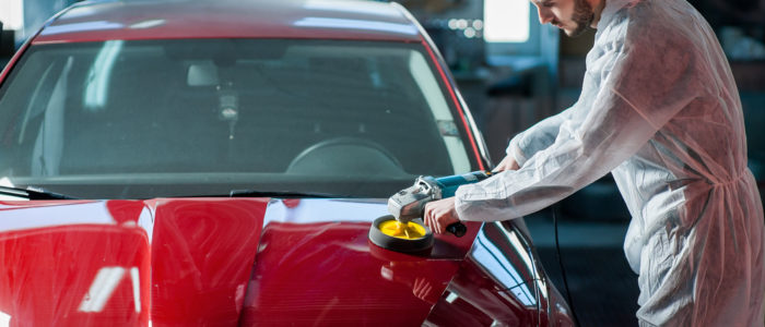 man waxing a car, professional car detailing experts